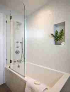 Clear Glass Partition with Rain Shower in a Modern Bathtub