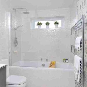 White Tiled Bathtub and Shower Combo in a Compact Size